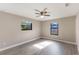 Comfortable bedroom with abundant natural light from two windows, complemented by a ceiling fan at 1022 Blue Horizon Dr, Deltona, FL 32725