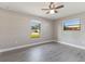 Bright bedroom featuring durable wood floors and a ceiling fan with light kit at 1022 Blue Horizon Dr, Deltona, FL 32725
