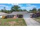 Traditional brick home featuring a 2 car garage and manicured lawn at 1022 Blue Horizon Dr, Deltona, FL 32725