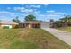Charming brick home featuring an attached garage, mature landscaping, and a well-manicured front lawn at 1022 Blue Horizon Dr, Deltona, FL 32725