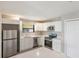 Modern kitchen with stainless steel appliances, white cabinets and quartz countertops at 1022 Blue Horizon Dr, Deltona, FL 32725