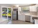 Stylish kitchen with stainless steel appliances and sliding glass door to back yard at 1022 Blue Horizon Dr, Deltona, FL 32725