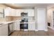 Bright kitchen with white cabinets, stainless steel appliances, and quartz countertops at 1022 Blue Horizon Dr, Deltona, FL 32725