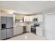 Bright kitchen with white cabinets, stainless steel appliances and breakfast bar at 1022 Blue Horizon Dr, Deltona, FL 32725