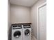 Functional laundry room featuring a modern washer and dryer set and additional storage space on shelves at 1022 Blue Horizon Dr, Deltona, FL 32725