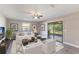 Bright living room with large windows, a sliding glass door, and modern furniture, perfect for relaxation at 1022 Blue Horizon Dr, Deltona, FL 32725
