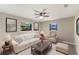 Inviting living room with natural light, a ceiling fan, and tasteful decor, creating a cozy atmosphere at 1022 Blue Horizon Dr, Deltona, FL 32725