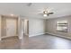 Spacious living room with hardwood floors, neutral paint, fan, door and window at 1022 Blue Horizon Dr, Deltona, FL 32725