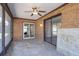 The enclosed patio features a ceiling fan, brick walls and sliding glass door at 1022 Blue Horizon Dr, Deltona, FL 32725