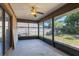 Enclosed screened patio with a ceiling fan, offering a view of the backyard, privacy fence and foliage at 1022 Blue Horizon Dr, Deltona, FL 32725