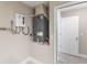 Utility room with tankless hot water system and A/C unit adjacent to doorway at 1022 Blue Horizon Dr, Deltona, FL 32725