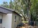 Exterior view of the home displaying air conditioning unit and backyard featuring lots of green foliage and shade at 1101 28Th Nw St, Winter Haven, FL 33881