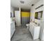 Bathroom with white vanity and modern sink, toilet and shower with yellow and gray curtain at 1101 28Th Nw St, Winter Haven, FL 33881