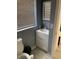 Cozy bathroom featuring a single sink vanity and a toilet with a window and gray walls at 1101 28Th Nw St, Winter Haven, FL 33881