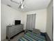 Comfortable bedroom with ceiling fan, dresser, and a patterned bedspread at 1101 28Th Nw St, Winter Haven, FL 33881