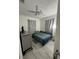 Bedroom featuring neutral walls and floors, ceiling fan and natural light, with closet, bed and side table at 1101 28Th Nw St, Winter Haven, FL 33881