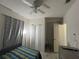 Bedroom featuring a ceiling fan, closet, and laminate floors at 1101 28Th Nw St, Winter Haven, FL 33881