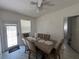Bright dining area with a table for six, door to backyard, and tile flooring at 1101 28Th Nw St, Winter Haven, FL 33881