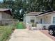 Cozy home featuring a driveway, manicured lawn, and outdoor seating area, perfect for enjoying the outdoors at 1101 28Th Nw St, Winter Haven, FL 33881