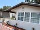 Charming home featuring a decorative front yard with well-maintained landscaping and white exterior at 1101 28Th Nw St, Winter Haven, FL 33881