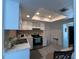 Kitchen with stainless appliances, white cabinetry, and a bright, modern design at 1101 28Th Nw St, Winter Haven, FL 33881