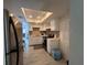 Kitchen with stainless steel refrigerator, white cabinets, and a bright skylight at 1101 28Th Nw St, Winter Haven, FL 33881