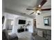 Comfortable living room with neutral colored sofa, tv, and decorative lighting and ceiling fan at 1101 28Th Nw St, Winter Haven, FL 33881