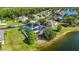 Aerial view of a two-story home with solar panels and screened pool area close to the lake at 12134 Shadowbrook Ln, Orlando, FL 32828