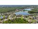 Panoramic aerial view of a neighborhood featuring beautiful homes and a tranquil lake with lush green surroundings at 12134 Shadowbrook Ln, Orlando, FL 32828
