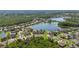 Areal view showing a quiet neighborhood nestled among mature trees and centered around a calm lake at 12134 Shadowbrook Ln, Orlando, FL 32828