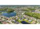 Extensive aerial panorama captures a community with peaceful lake, surrounded by lush green trees and lawns at 12134 Shadowbrook Ln, Orlando, FL 32828