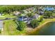 Aerial view of a two-story home with solar panels and screened pool area close to the lake at 12134 Shadowbrook Ln, Orlando, FL 32828