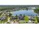 Stunning aerial view of homes surrounding a serene lake, showcasing lush greenery and beautiful landscaping at 12134 Shadowbrook Ln, Orlando, FL 32828