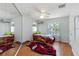 Themed bedroom with car-shaped bed, car rug, ceiling fan and ample natural light at 12134 Shadowbrook Ln, Orlando, FL 32828