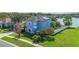 Picturesque two-story lakefront home with solar panels, mature landscaping, and covered side-entry garage at 12134 Shadowbrook Ln, Orlando, FL 32828