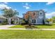 Charming two-story home with a well-manicured lawn, porte-cochere, and classic architectural details at 12134 Shadowbrook Ln, Orlando, FL 32828