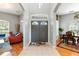 Grand foyer with double doors, tile flooring, transom window, and views into the living and dining areas at 12134 Shadowbrook Ln, Orlando, FL 32828
