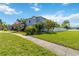 Charming two-story home with mature trees, landscaped lawn and sidewalk entry at 12134 Shadowbrook Ln, Orlando, FL 32828