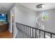 Hallway with a decorative chandelier and a wrought iron railing at 12134 Shadowbrook Ln, Orlando, FL 32828