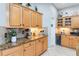 Granite counters, mosaic backsplash and stainless wine cooler are features of this kitchen at 12134 Shadowbrook Ln, Orlando, FL 32828