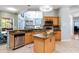Updated kitchen features granite counters, stainless steel appliances, and a central island with ample counter space at 12134 Shadowbrook Ln, Orlando, FL 32828