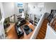 Aerial view of the living room showcasing a two-story ceiling, large sectional sofa, and wood flooring at 12134 Shadowbrook Ln, Orlando, FL 32828