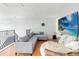 Loft area with comfortable seating, wood flooring, and a mounted television at 12134 Shadowbrook Ln, Orlando, FL 32828