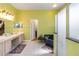 Bathroom features a dual sink vanity, a walk-in shower, and a garden tub for luxurious bathing at 12134 Shadowbrook Ln, Orlando, FL 32828