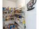 Organized pantry with wire shelving filled with a variety of food items and a cute Coffee & Tea sign at 12134 Shadowbrook Ln, Orlando, FL 32828