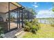 A beautiful enclosed pool area with outdoor kitchen and lush landscaping on the lake at 12134 Shadowbrook Ln, Orlando, FL 32828