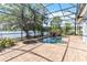 Gorgeous pool and jacuzzi area with screened-in enclosure and lake views at 12134 Shadowbrook Ln, Orlando, FL 32828