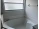 Clean bathroom featuring a soaking tub with a textured privacy window at 123 S Roma Way, Kissimmee, FL 34746