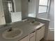 Bright bathroom with double sinks, a large mirror, and separate shower and tub areas at 123 S Roma Way, Kissimmee, FL 34746
