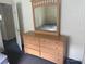 Spacious bedroom features a large dresser and mirror, perfect for storage and style at 123 S Roma Way, Kissimmee, FL 34746